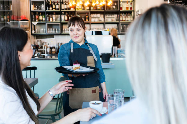 istock Young woman with Down Syndrome working at cafe 1345310788