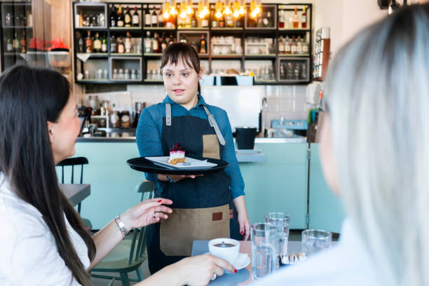 istock Young woman with Down Syndrome working at cafe 1345310817
