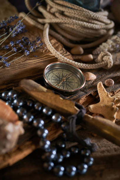 istock A marine concept with a bottle, starfish, seashells, rope, compass and paper scroll, pirate still life 1345310998