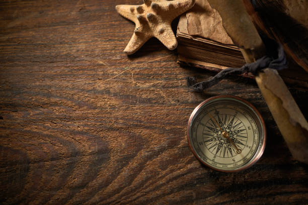 istock A marine concept with a bottle, starfish, seashells, rope, compass and paper scroll, pirate still life 1345311050