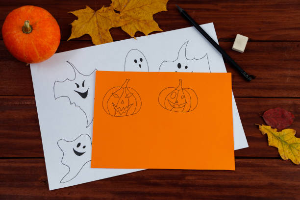 istock Halloween DIY. Cute pumpkins and paper ghosts. Step-by-step instruction. 1345312288