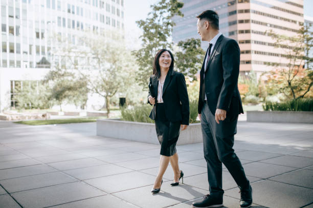 istock Business Colleagues Discuss Work as They Walk To the Office 1345313165