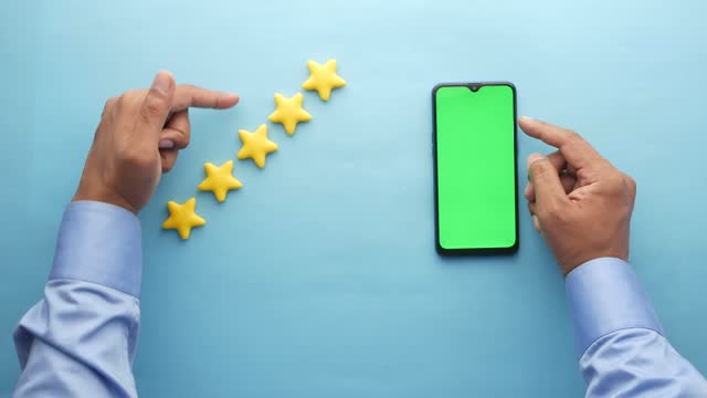 Customer review concept. Rating golden stars and using smart phone