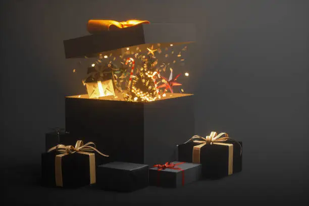 Open black gift box with various Christmas gifts inside.