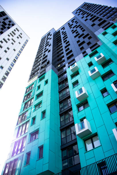 istock bottom view of a multi-storey modern aqua colored building. urban jungle 1345321040