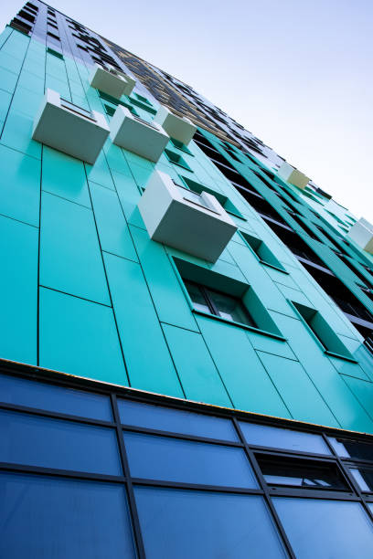 istock bottom view of a multi-storey modern aqua colored building . urban jungle 1345323447