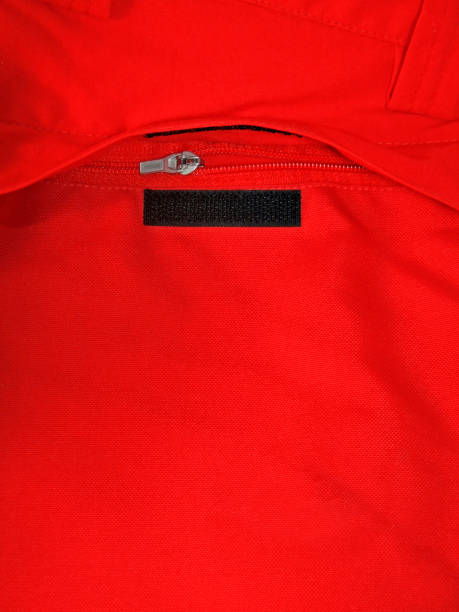 istock Zipper and velcro pocket opening on red fabric 1345323488