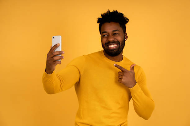 istock Afro man taking selfies with a mobile phone. 1345324631