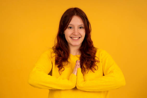istock Woman smiling while keeping hands together asking something. 1345325135