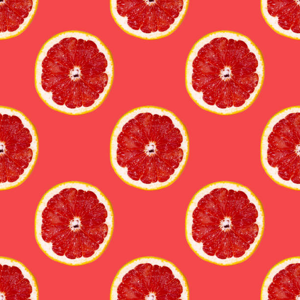 istock Grapefuit slices seamless pattern over red background, top view 1345325447