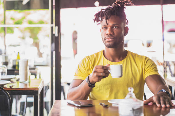 istock Man drinking a cup of coffee at a coffee shop. 1345326254