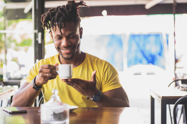 istock Man drinking a cup of coffee at a coffee shop. 1345326291