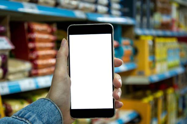 istock Woman using smartphone at the supermarket. 1345326327