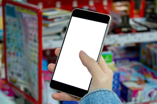 istock Woman using smartphone at the supermarket. 1345326377