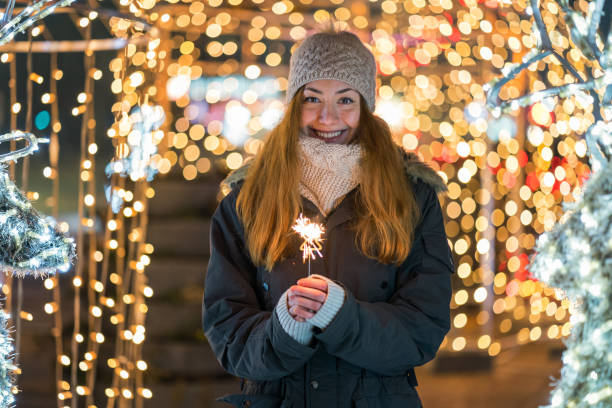 istock Woman lighting a sparkler candle 1345326510