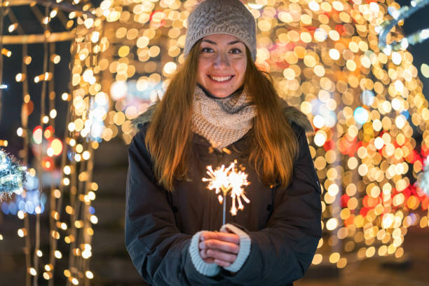 istock Woman lighting a sparkler candle 1345326514