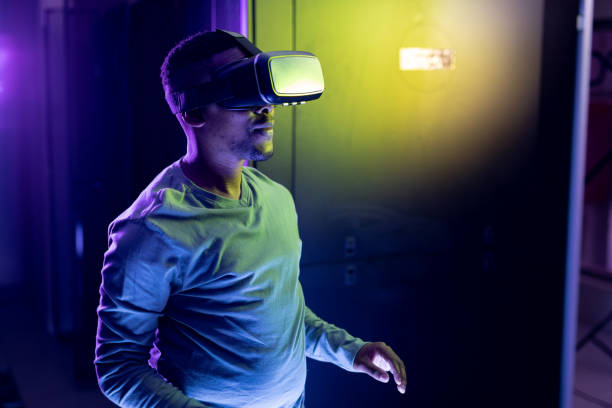 istock African american male computer technician wearing vr headset and working in server room 1345326811