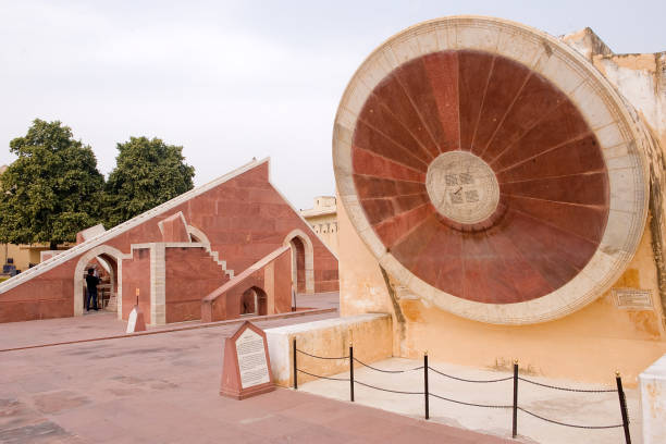 India Jaipur, (Rajasthan State) India - February 21 2014: The Nadi Valaya Yantra (two sundials on different faces of the instrument, the two faces representing north and south hemispheres; measuring the time to an accuracy of less than a minute). - The Jantar Mantar is an observatory, with a collection of 19 astronomical instruments,  built by Maharajah Jai Singh II between 1727 and 1734. It is UNESCO World Heritage site and it’s found near the City Palace and the Hawa Mahal. jaipur photos stock pictures, royalty-free photos & images