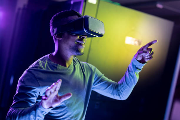 istock African american male computer technician wearing vr headset and working in server room 1345326924