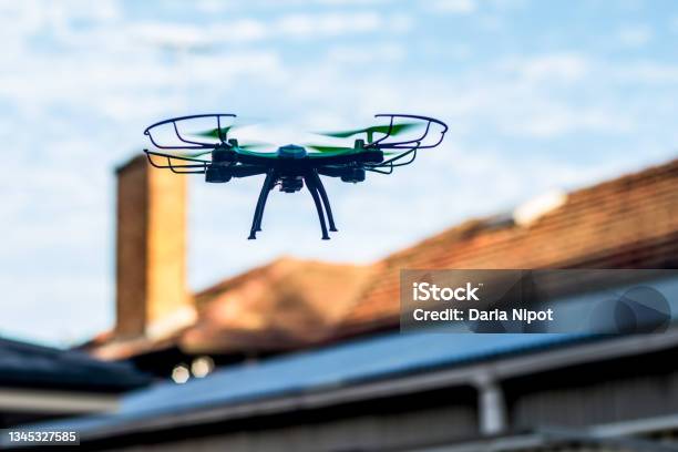 Drone Quad Copter Flying Over The Roofs Drone Photography And Videography Toy Drone Copy Space Stock Photo - Download Image Now