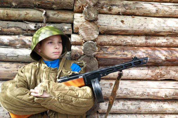 istock Serious child posing with PPSh-41 submachine gun 1345328699