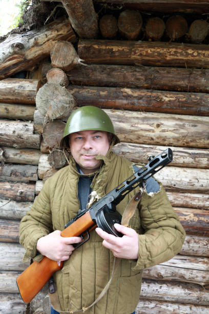 istock Soldier posing with PPSh-41 submachine gun 1345329444