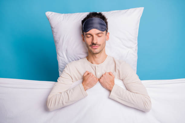 Top above high angle view portrait of nice calm guy sleeping on soft bed linen isolated over bright blue color background.