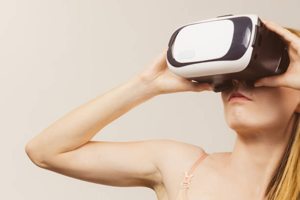 istock Girl wearing virtual reality goggles. 1345333963