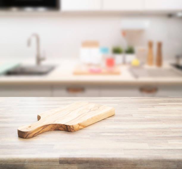istock Wood table top on blur kitchen room 1345336211