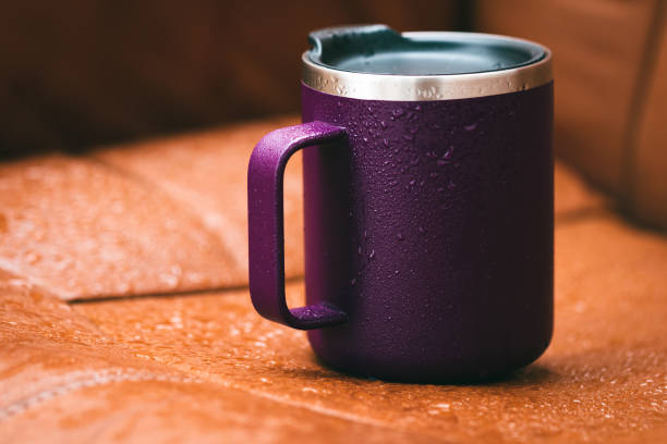 Purple color isothermal mug in the rain