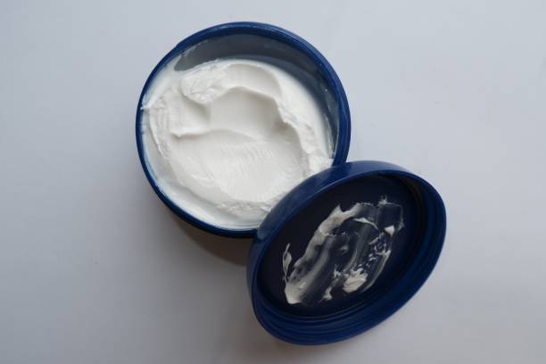 istock A white skin moisturizing cream in a blue container 1345337893