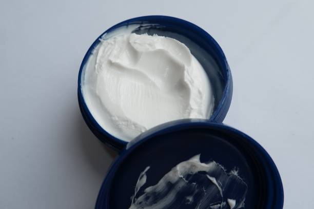 istock A white skin moisturizing cream in a blue container 1345337904