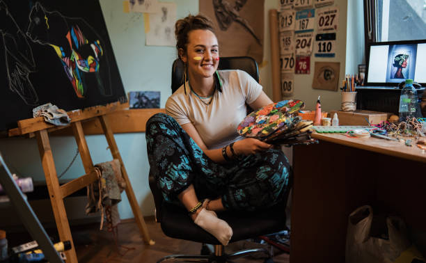 istock Lovely and creative female small business owner, in her creative home workshop 1345339908