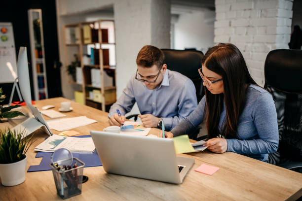 istock Two young businessman having a successful meeting in modern office. 1345341583