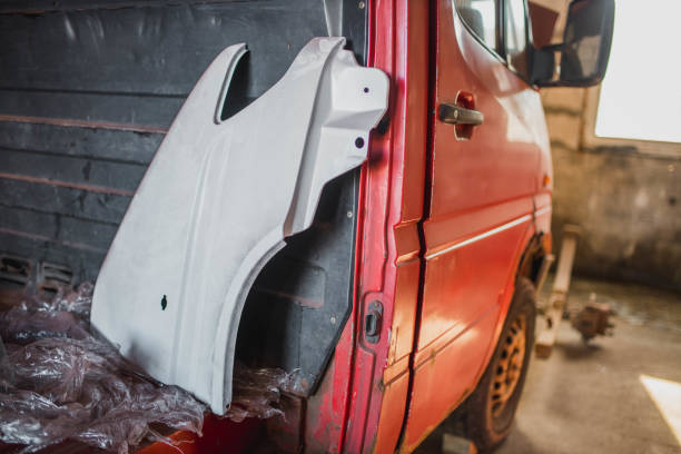 istock body work on car painting, metal processing with epoxy primer, restoration of body elements. 1345341702