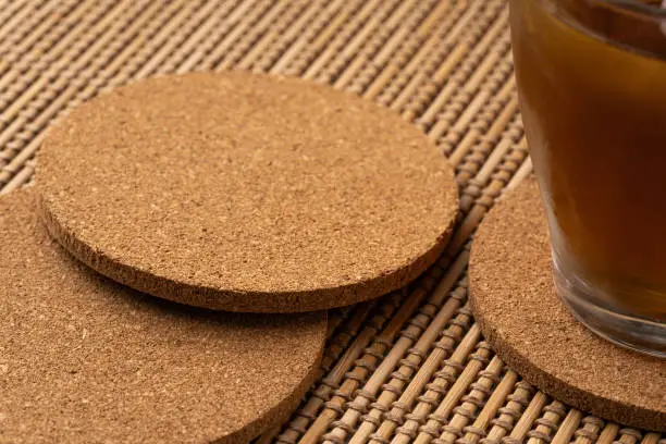 Cork coasters and glasses with water drops