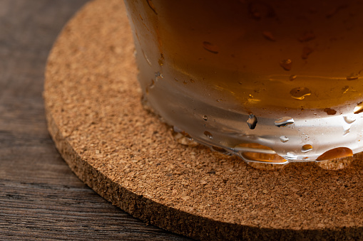 Cork coasters and glasses with water drops