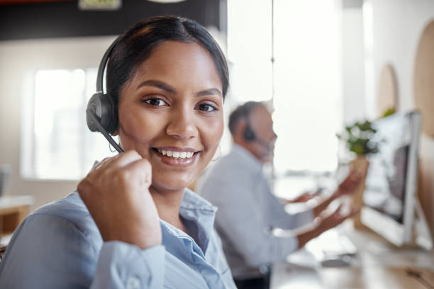 istock Portrait of a young woman using a headset in a modern office 1345344865