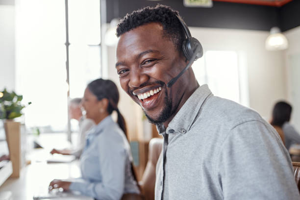 istock Portrait of a young man using a headset in a modern office 1345345637