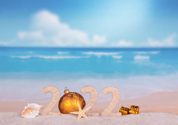 istock New Year 2022 on hot beach with seashells and starfish 1345345936