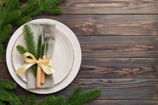 istock Christmas table place setting with christmas decor and plates, kine, fork and spoon. Christmas holiday background. Top view with copy space 1345345993