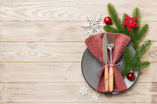 istock Christmas table place setting with christmas decor and plates, kine, fork and spoon. Christmas holiday background. Top view with copy space 1345346008