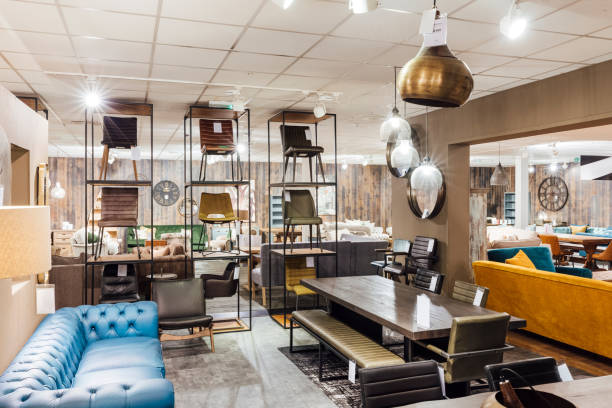 Wide angle shot showcasing a colourful selection of chairs and furniture in a showroom, lights beaming through illuminating the store.