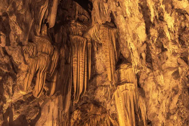 Stalactite formations hanging from the ceiling of Dim Cave in Alanya, Turkey.