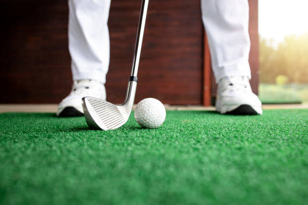 istock Golfer preparing to hit the ball at golf course. 1345347527