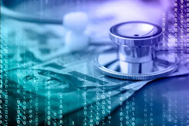 Photo of Abstract technology background with binary code, US dollars and a stethoscope