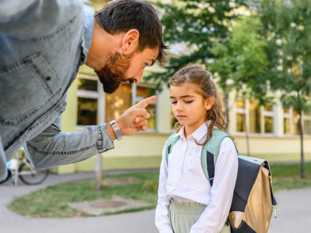Father scolding his daughter Father scolding his daughter in front of the school ignoring photos stock pictures, royalty-free photos & images