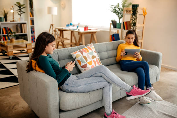 istock Girls enjoy themselves at home while using the tablet 1345348983