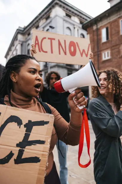 Photo of Anti-racism protest in the city street. A group of students marching together