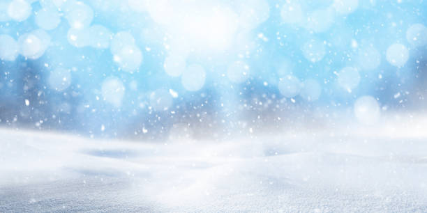 istock Blurred snowy background with snowflakes 1345349389